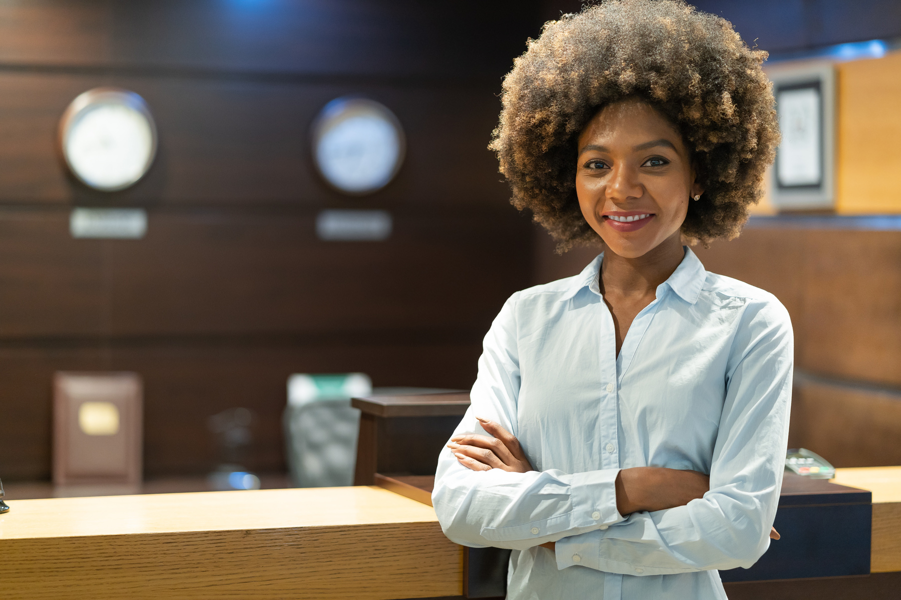 African female receptionist standing in hotel